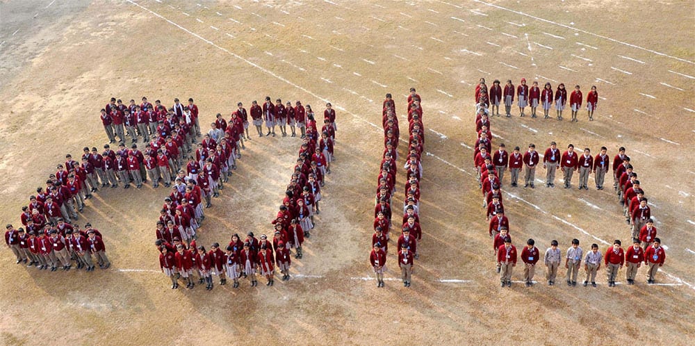 Students stand in a formation that reads 2016 ahead of New Year celebrations at a school in Agartala.