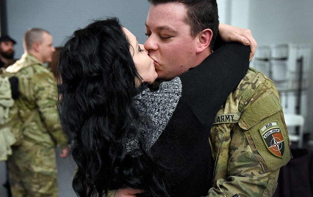 Sgt. Christopher Cruz of Danbury kisses his girlfriend, Amber Gerard, of Brewster, N.Y, after arriving at the National Guard's Windsor Locks Army Aviation Readiness Center in Windsor Locks, Conn.