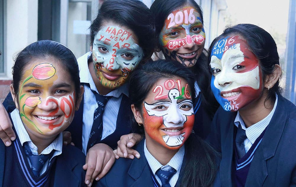 School girls paint their faces with New Year greetings and wishes in Gurgaon.