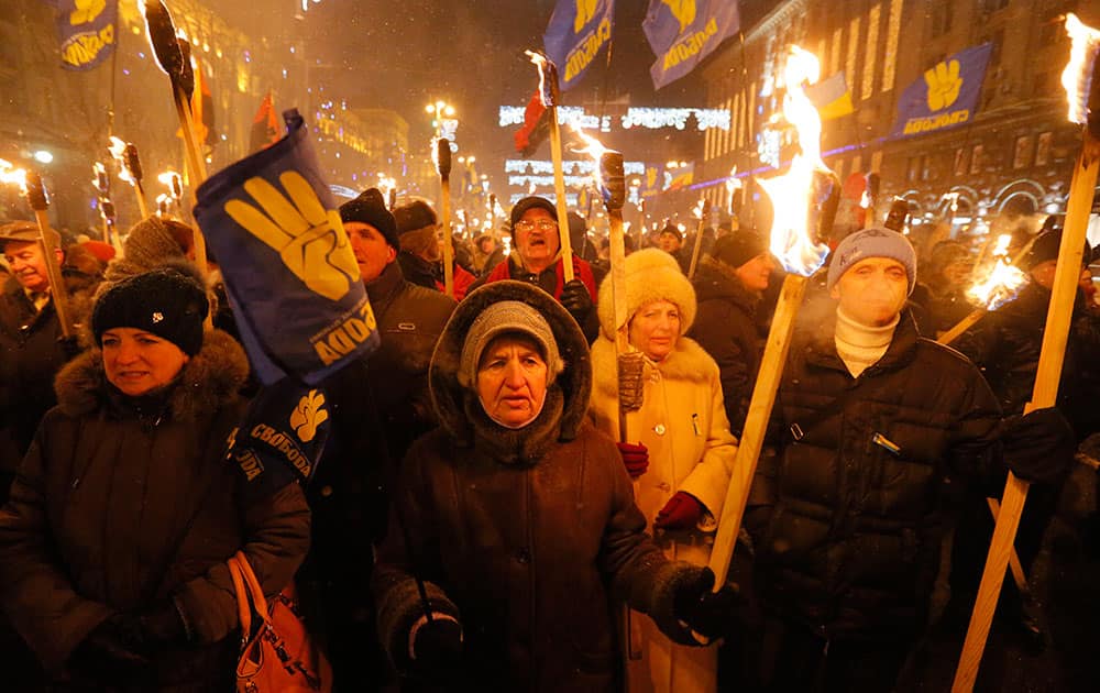 Ukrainian nationalists carry burning torches during a rally in downtown Kiev, Ukraine