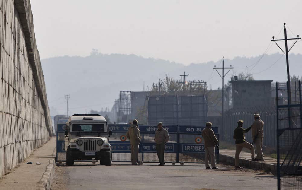 Indian soldiers stand outside an Indian air force base in Pathankot