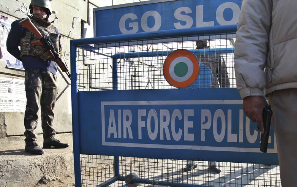 Indian security forces stand outside an Indian air force base in Pathankot