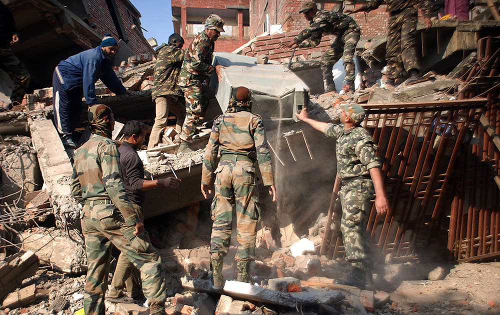 Indian soldiers remove debris from a damaged building after an earthquake in Imphal, Manipur. A 6.7 magnitude earthquake hit India's remote northeast region before dawn on Monday. 