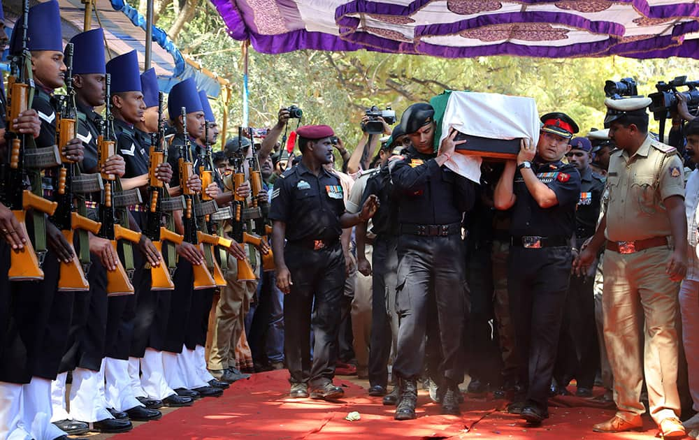 The body of India's National Security Guard commando, Niranjan Kumar, is carried by Indian soldiers as they pay their last respects in Bangalore.