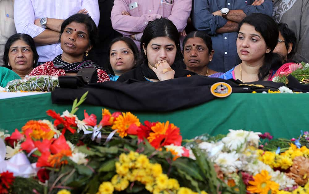 Radhika looks at the coffin of her husband and India's National Security Guard commando, Niranjan Kumar, who was among those killed in the attack on the Pathankot air force base after the body was brought to Bangalore.