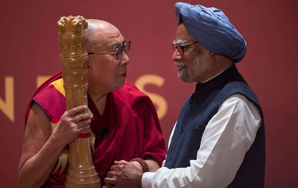 Tibetan spiritual leader the Dalai Lama receives a souvenir from former prime minister Manmohan Singh at an event to celebrate his 80 years in New Delhi.
