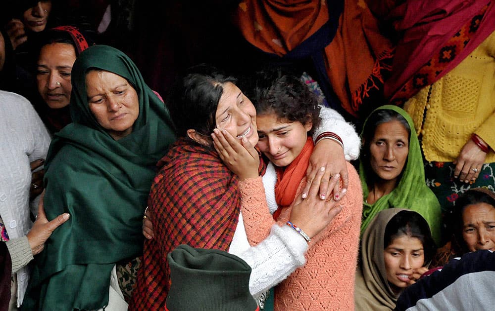Daughters of martyr Sanjeevan Singh Rana, who was killed in terrorist attack in Pathankot, wail during his funeral at his native village Siyunh near Shahpur in Himachal Pradesh.