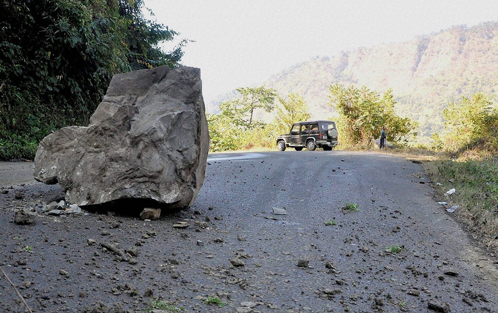 A boulder comes down off a hill at NH-31 at Noney village in Tamenglong district after a massive earthquake.