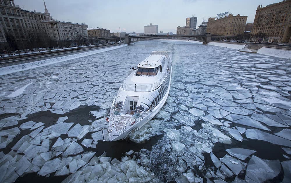 A tourist boat with restaurant aboard, especially designed for winter rivers, cruises the frozen Moskva River in Moscow, Russia.