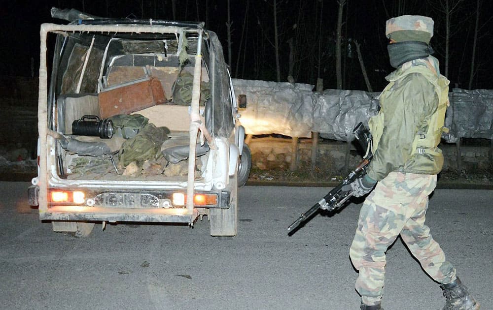 Security forces jawan guard near the site of grenade attack by militants at a CRPF camp at Mominabad in Anantnag district of South Kashmir.