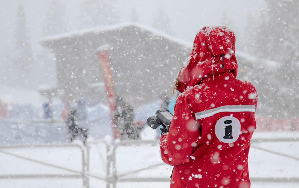 an employee stands as snow falls at Northstar California.