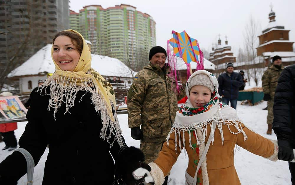 Ukrainians celebrate Orthodox Christmas in Kiev, Ukraine, Thursday, Jan. 7 2016. Orthodox Christians mark their traditional Christmas Day Jan. 7, with many ancient symbolic events.