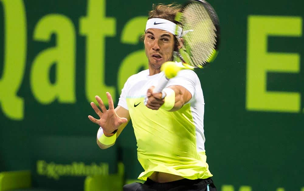 Spain's Rafael Nadal returns the ball during a match against Andrey Kuznetsov of Russia at Qatar Open tennis tournament.