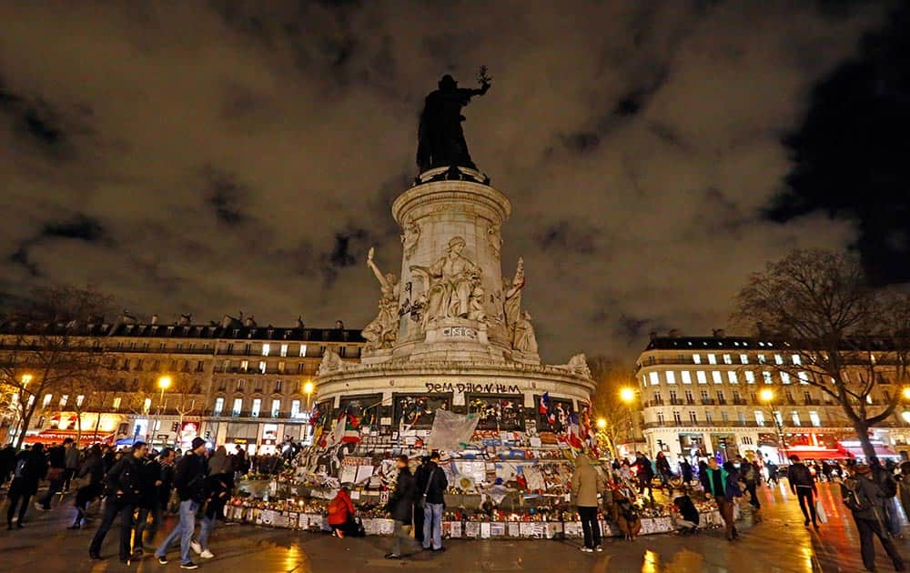 People walk around on the Place de la Republique during a gathering that marks one year after the attacks on Charlie Hebdo satirical newspaper, in Paris, France, 