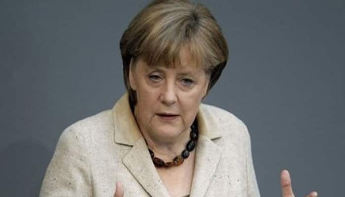 Germany&#039;s Merkel toughens tone on migrants as protesters gather