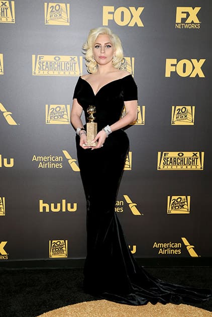 Lady Gaga poses with her award for best performance by an actress in a limited series or a motion picture made for television for 