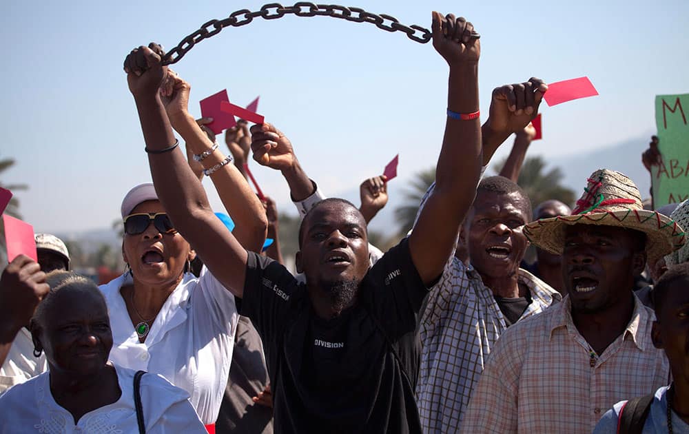 Demonstrator chant anti-government slogans during a protest against the installation of the Haitian parliament in Port-au-Prince, Haiti.