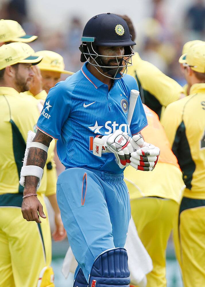 India's Shikhar Dhawan walks back to the pavilion after loosing his wicket during their one day international cricket match against Australia in Perth, Australia.