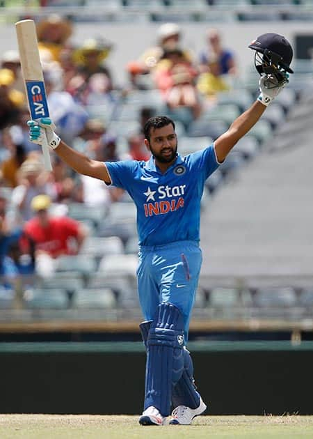 Rohit Sharma raises his bat after scoring a century during their one day international cricket match against Australia in Perth, Australia.