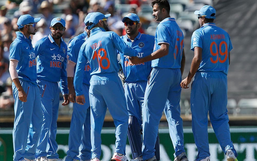 Barinder Sran is congratulated by teammates after taking a wicket during their one day international cricket match against Australia in Perth, Australia.