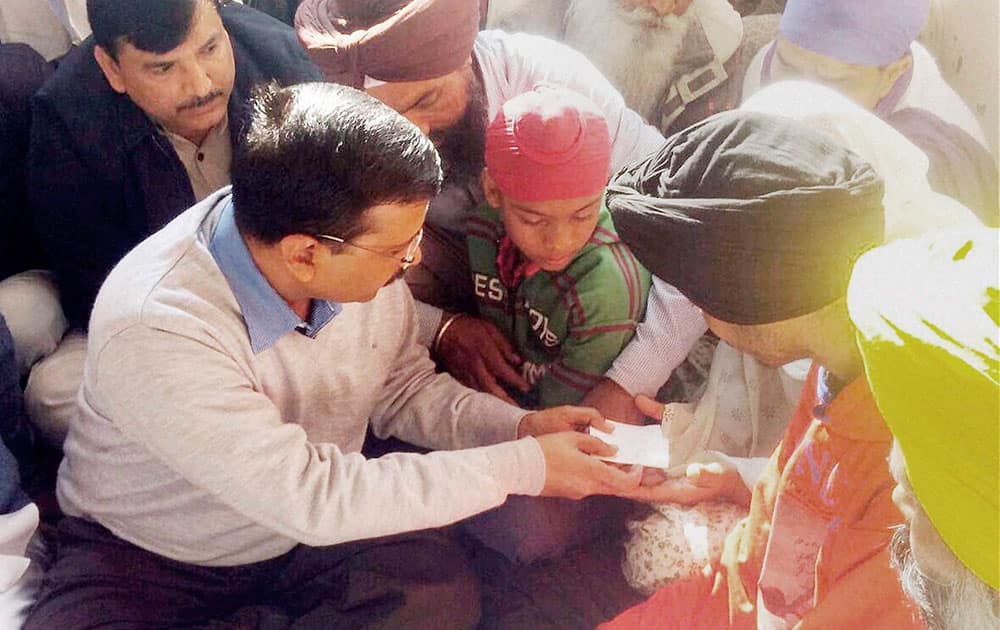 Delhi Chief Minister Arvind Kejriwal meeting the family of martyr Lance N/K Kulwant Singh at his village Chak Sharif in Gurdaspur on Wednesday. Singh was killed in the Pathankot airbase attack.