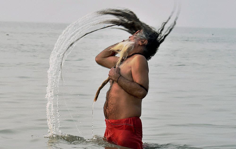 A sadhu takes a holy dip at Gangasagar, the confluence of River Ganga and Bay of Bengal on the occasion of Makarsankranti.