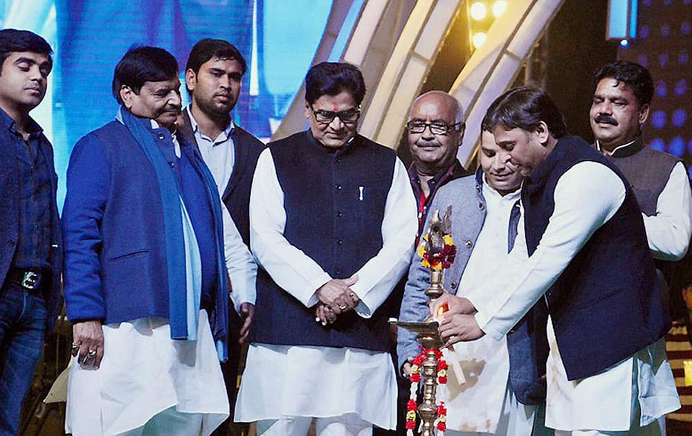 Chief Minister of Uttar Pradesh Akhilesh Yadav lighting lamps as MP Ram Gopal Yadav, Shivpal Singh Yadav and others look on during a cultural program at Saifai Mohotsav in Saifai.