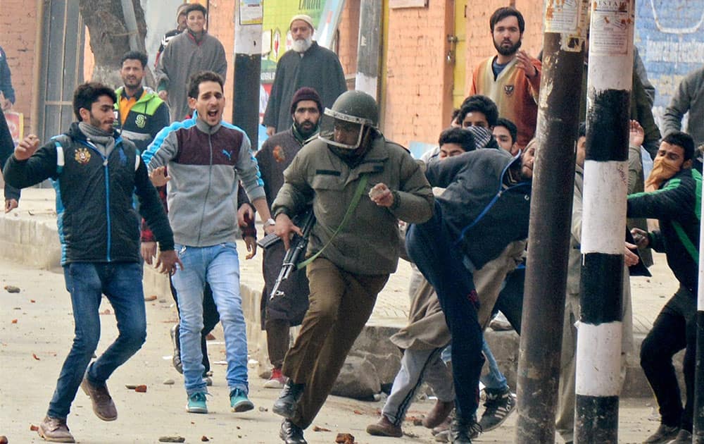 Angry protesters beating up a policeman during clashes on Srinagar-International Airport Road at Peerbagh in Srinagar.