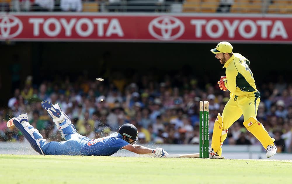 Virat Kohli, left, is run out by Australia's Matthew Wade, right, during the 2nd One Day International cricket match between Australia and India in Brisbane, Australia.