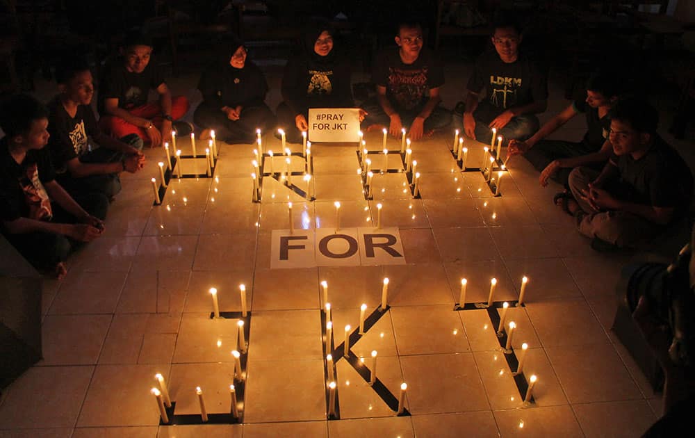 Students light candles during a solidarity for those affected by a deadly attack in Jakarta, during a vigil in Surabaya, East Java, Indonesia.