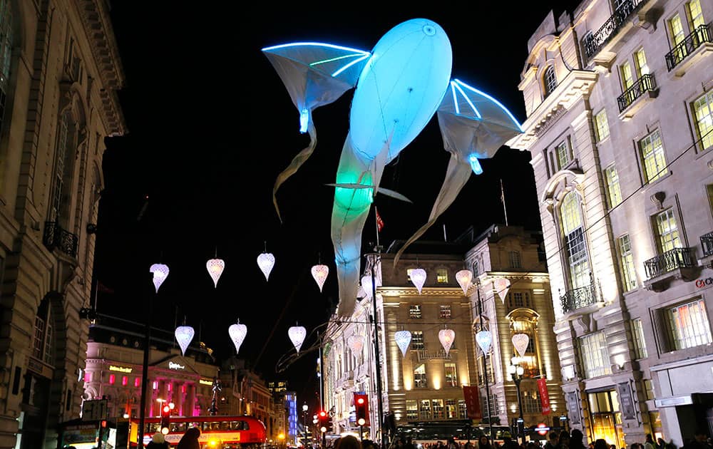 'Les Lumineoles' by artist 'Porte Par Le Vent flies above Piccadilly in London.
