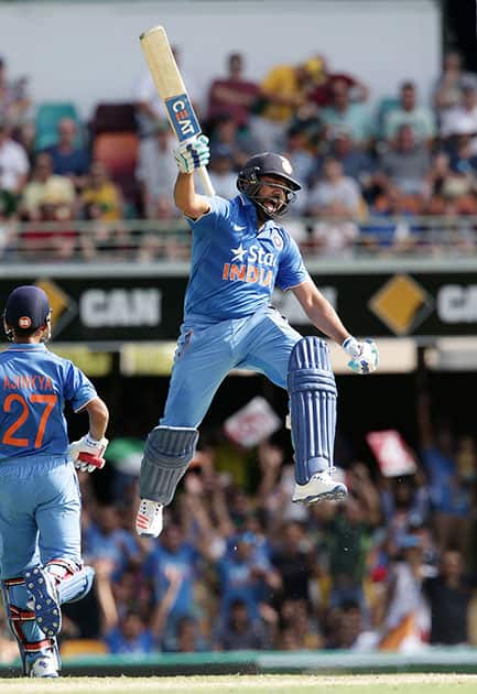 Rohit Sharma celebrates after reaching 100 runs during the 2nd One Day International cricket match between Australia and India in Brisbane, Australia.