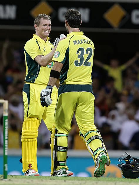 George Bailey celebrates with Glen Maxwell after they defeated India during the 2nd One Day International cricket match in Brisbane, Australia.
