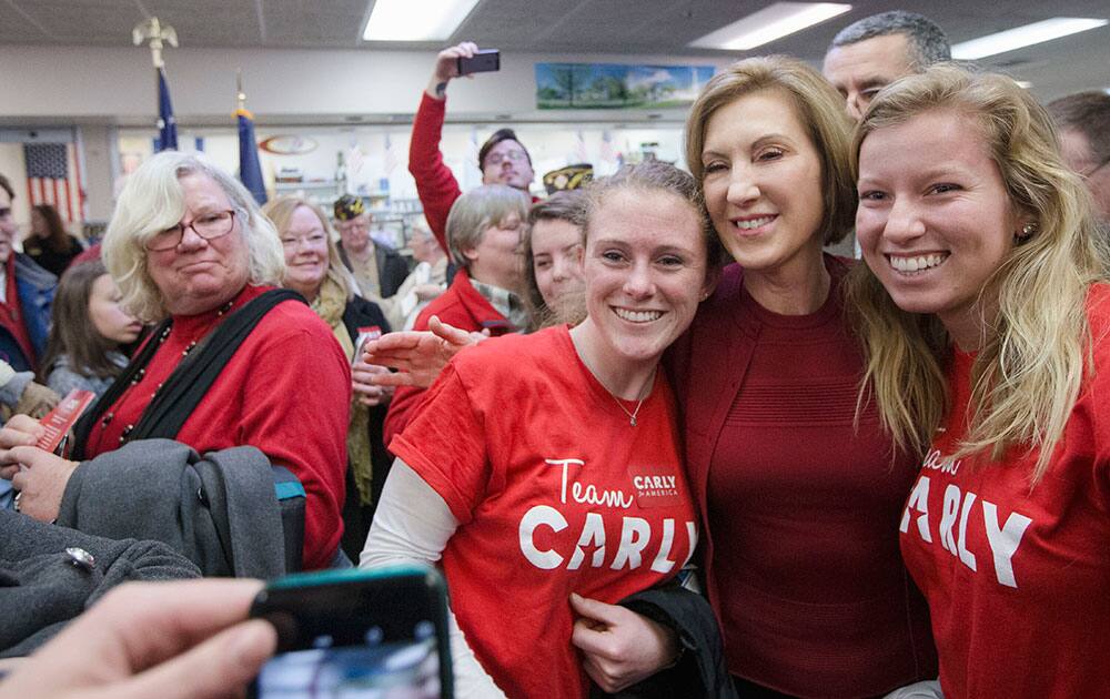Republican presidential candidate, businesswoman Carly Fiorina has a selfie taken with supporters during a campaign stop at Hollis Pharmacy, in Hollis, N.H.
