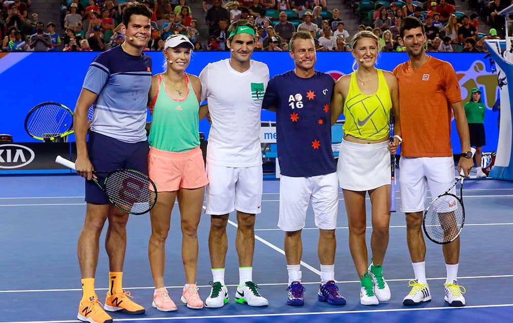 Tennis players from left to right, Milos Raonic of Canada, Caroline Wozniacki of Denmark, Roger Federer of Switzerland, Lleyton Hewitt of Australia, Victoria Azarenka of Belarus and Novak Djokovic of Serbia pose for a group photo during the Kids Tennis Day, an exhibition event on Rod Laver Arena, ahead of the Australian Open tennis championships in Melbourne, Australia