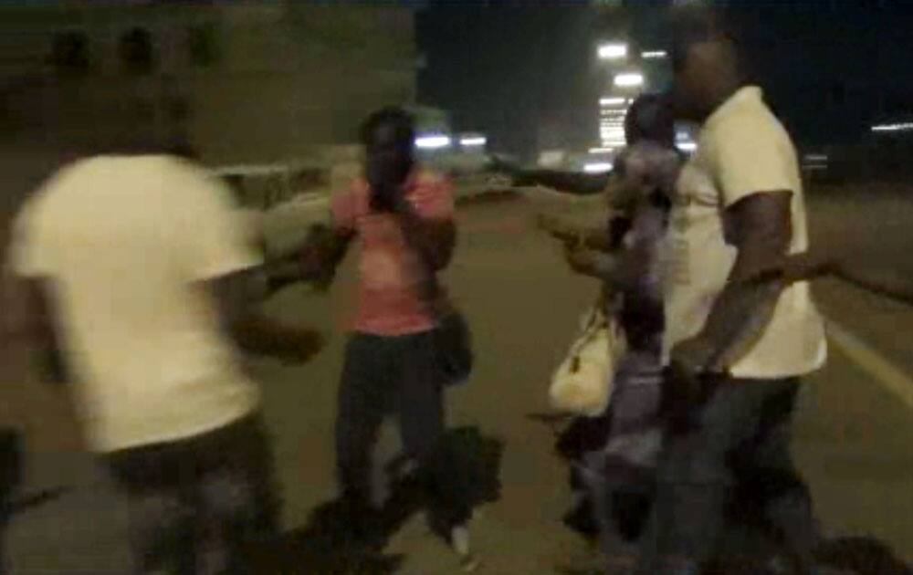 PLAIN-CLOTHED POLICEMEN LEADS PEOPLE AWAY NEAR THE SPLENDID HOTEL IN OUAGADOUGOU, BURKINA FASO. THE SITE INTELLIGENCE GROUP REPORTS THAT AN AL-QAIDA AFFILIATE IS CLAIMING RESPONSIBILITY FOR THE ONGOING SIEGE ON AN UPSCALE HOTEL AND CAFE IN BURKINA FASO'S CAPITAL WHERE AN UNKNOWN NUMBER OF HOSTAGES ARE BEING HELD.
