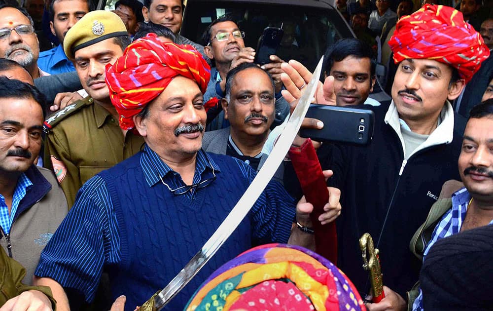 Defence Minister Manohar Parrikar and Minister of State for Ministry of Information and Broadcasting Rajyavardhan Singh Rathore being welcomed at BJP office in Jaipur.