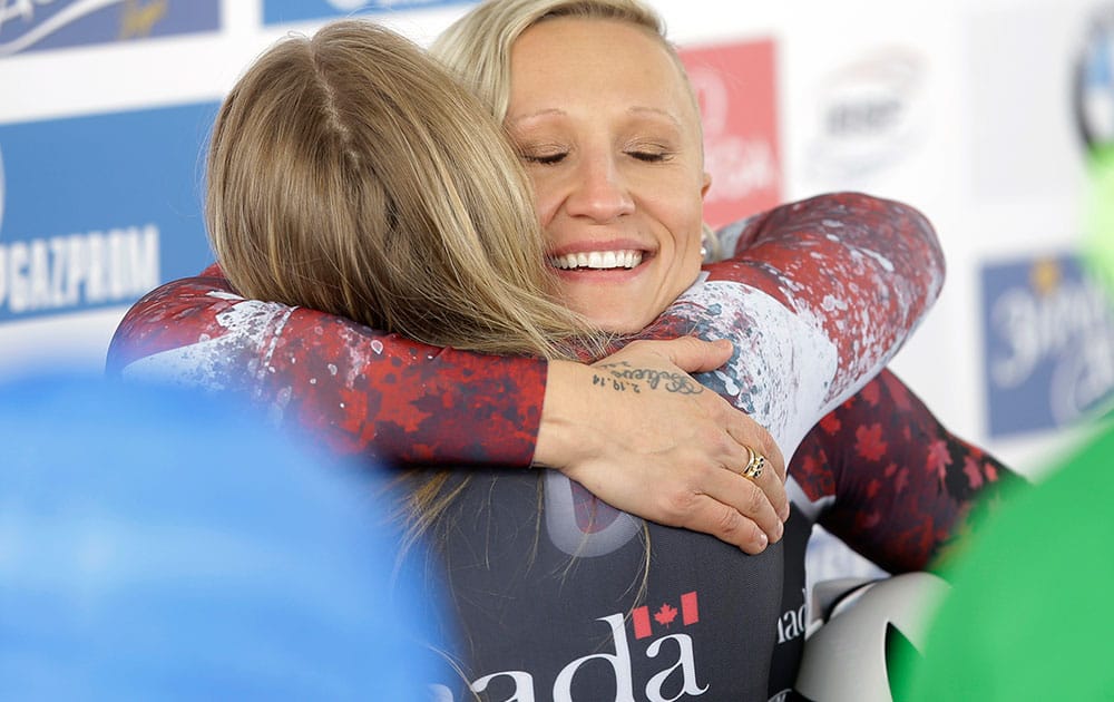 Canada's driver Kaillie Humphries, right, and brakeman Melissa Lotholz hug after competing in the women's bobsled World Cup race in Park City, Utah.