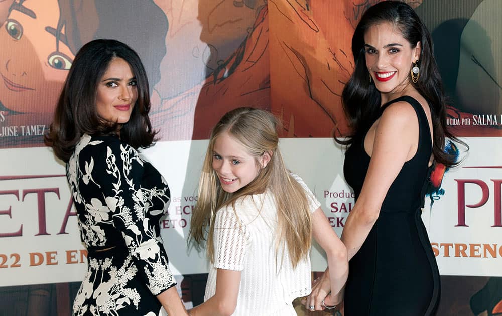 Mexican actress and producer Salma Hayek, from left, child actress Loreto Peralta, and Mexican actress and singer Sandra Echeverría, pose for pictures during a news conference to promote their movie 