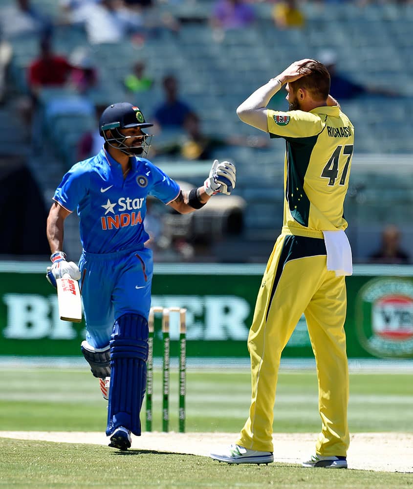 India's Virat Kohli, left, takes off for a run watched by Australia's Kane Richardson during their one day international cricket match in Melbourne, Australia.