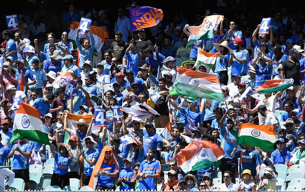 Indian fans cheer their team during their one day international cricket match against Australia in Melbourne, Australia.