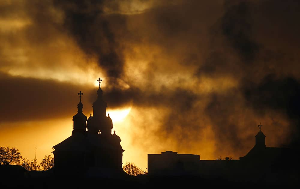 The sun rises above Orthodox Church, left, and Catholic Church in the town of Novogrudok, 150 kilometers ( 93 miles ) west of the capital Minsk, Belarus.