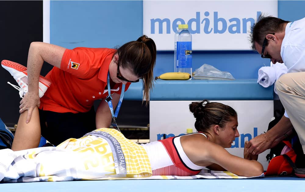Sara Errani of Italy receives treatment during her first round loss to Margarita Gasparyan of Russia at the Australian Open tennis championships in Melbourne, Australia, Monday, Jan. 18, 2016.