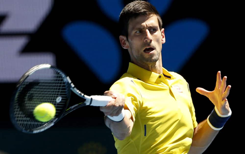 Novak Djokovic of Serbia makes a forehand return to Chung Hyeon of South Korea during their first round match at the Australian Open tennis championships in Melbourne, Australia, Monday, Jan. 18, 2016.