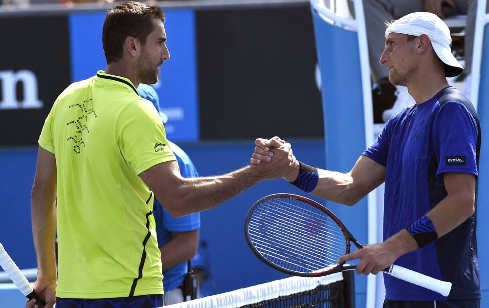 Marin Cilic, left, of Croatia is congratulated by Thiemo de Bakker of the Netherlands during their first round match at the Australian Open tennis championships in Melbourne, Australia, Monday, Jan. 18, 2016.