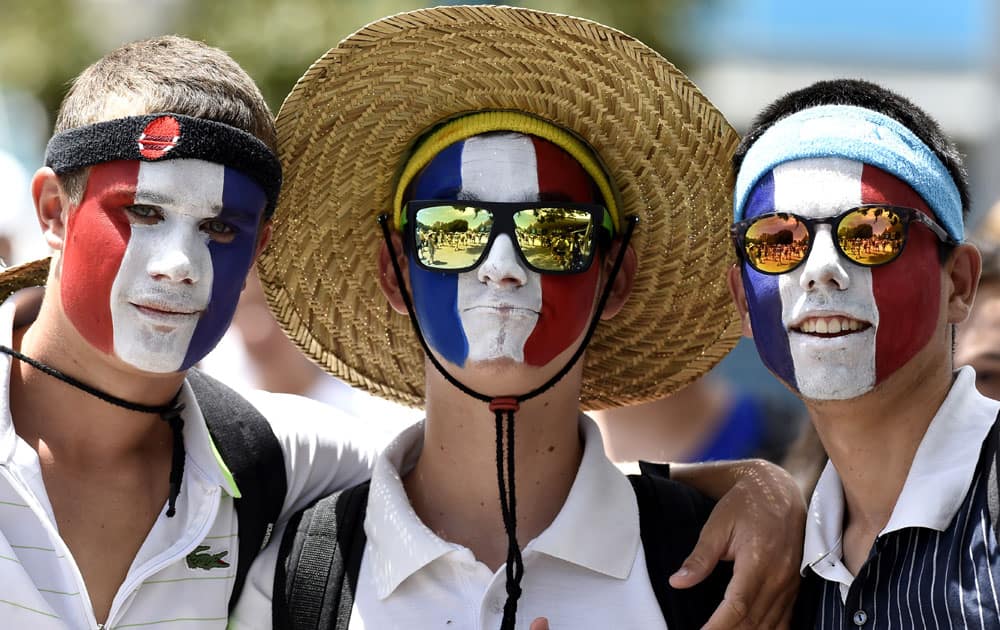 Supporters with their face painted in French flag color are seen during a first round match at the Australian Open tennis championships in Melbourne, Australia, Monday, Jan. 18, 2016.