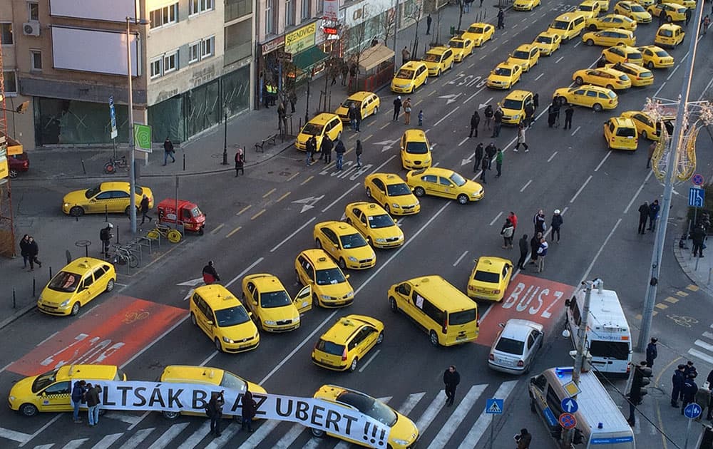 Budapest taxis drivers block traffic as they protest demanding a ban on Uber in downtown Budapest, Hungary.