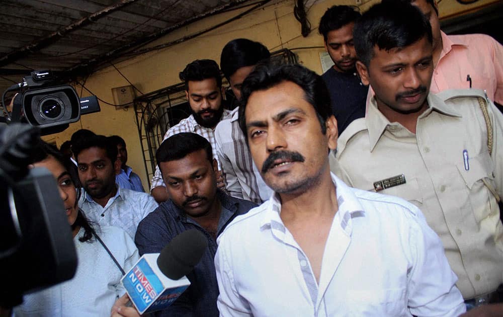 Actor Nawazuddin Siddiqui speaks with media persons at Versova Police Station in Mumbai.