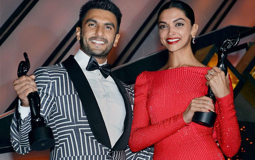 Best Actor Award winner Ranveer Singh and Deepika Padukone pose their trophies during the Filmfare Awards in Mumbai.