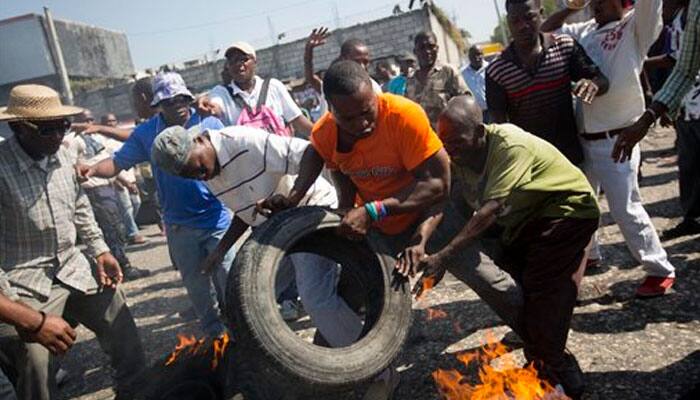 Protesters vow to derail Haiti presidential vote; election offices burned